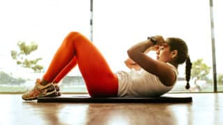 Woman doing a crunch on an exercise mat